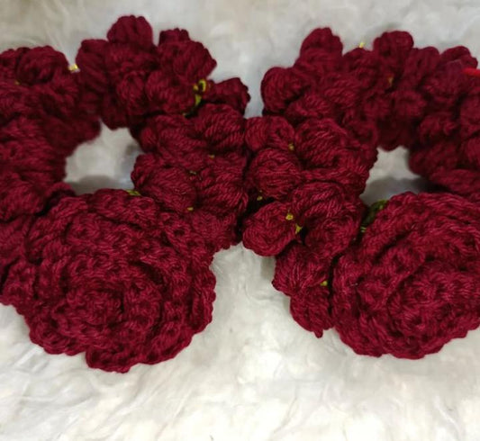 Pink crochet flower bracelet with dangling flowers worn on wrist